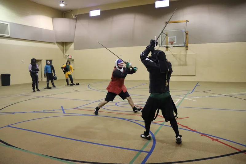 Neal and Jason mid-longsword fight.