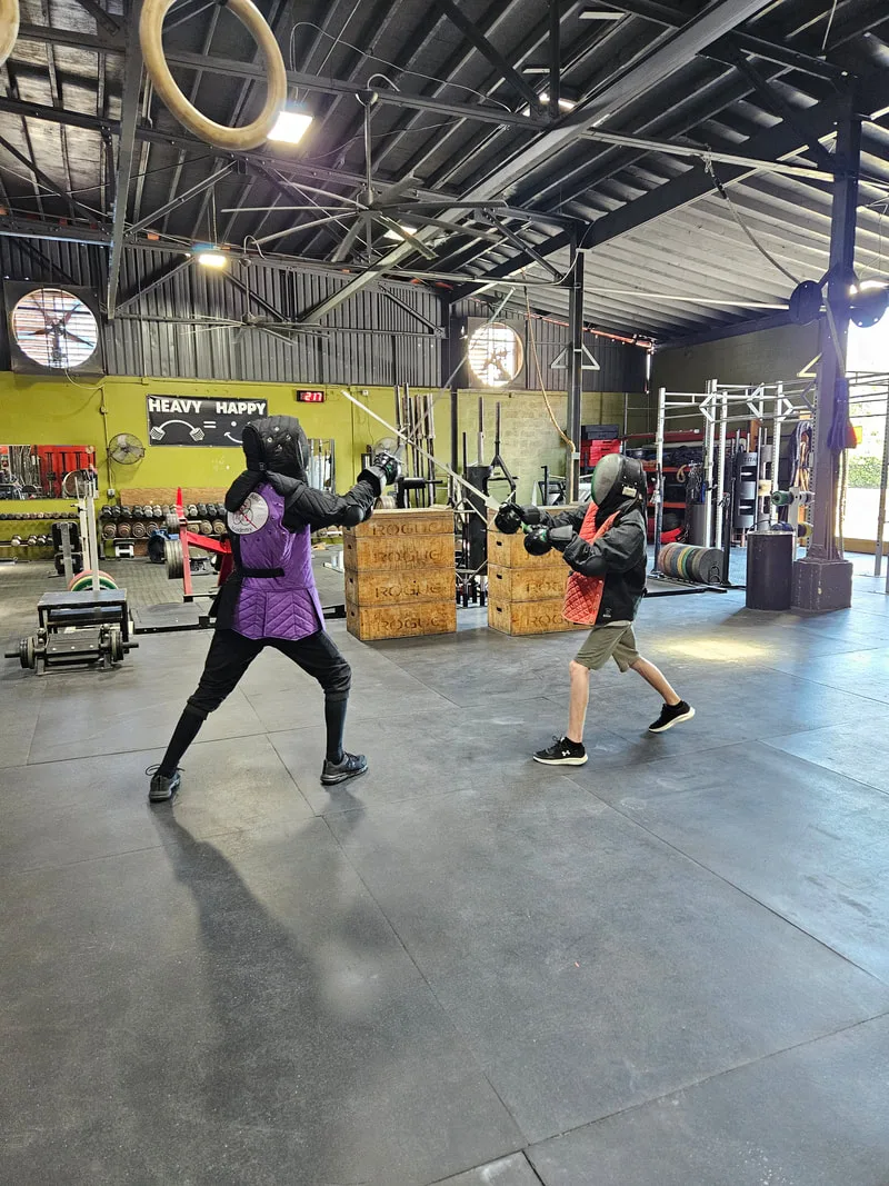 Braam and teen student doing a longsword drill.