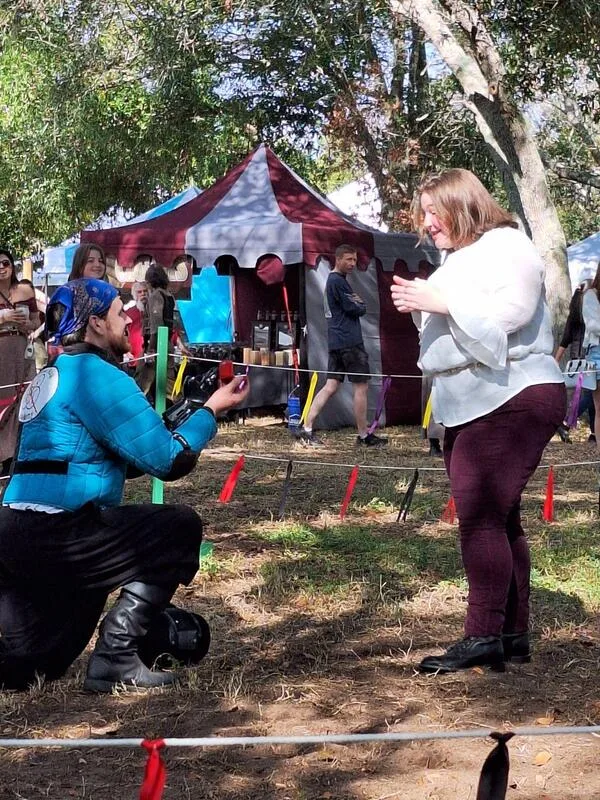 Instructor Ryan proposing to his partner Stephanie during a demonstration at the Suncoast Renaissance Festival.